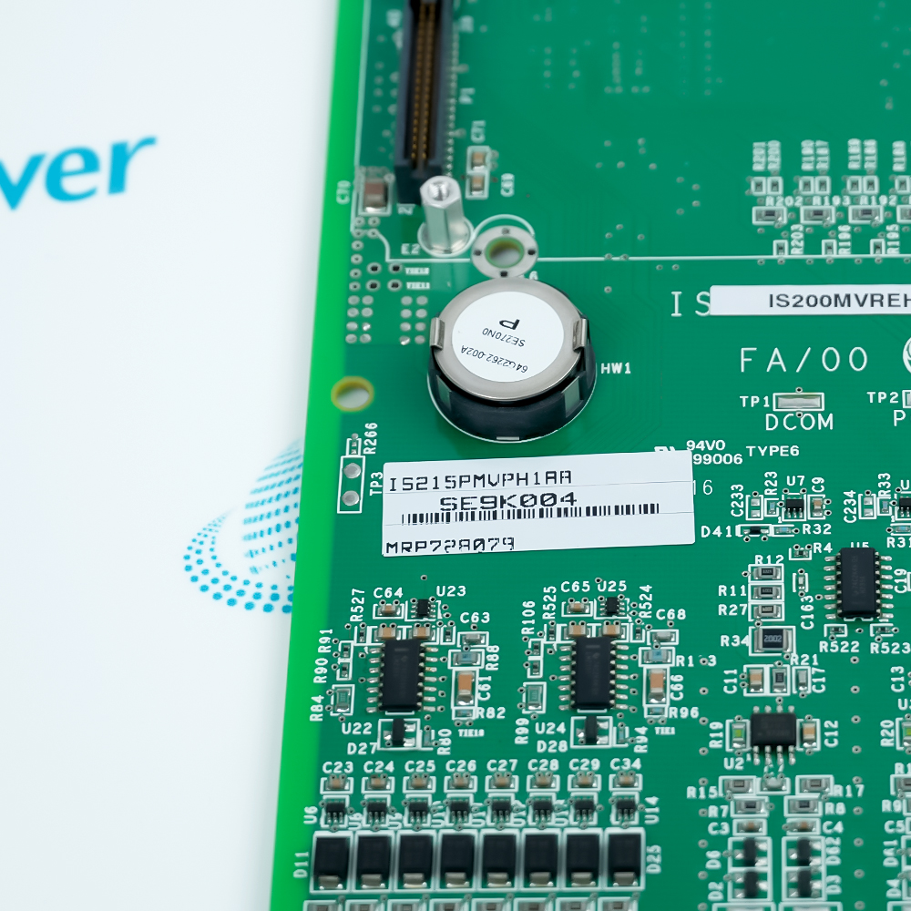 Close-up of the board label reading IS215PMVPH1AA alongside a large white cylindrical capacitor and surface-mount ICs