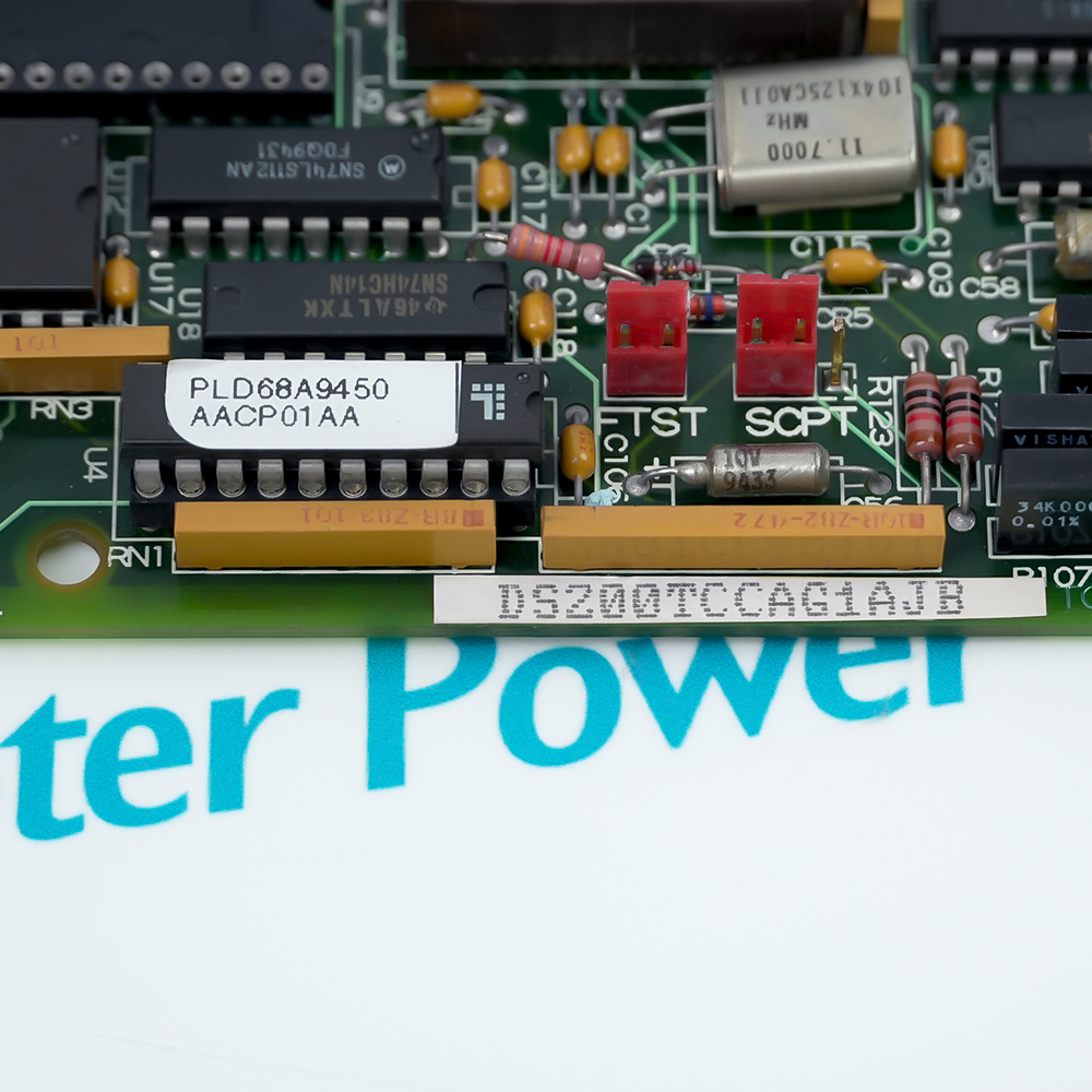 Close-up of the board marking DS200TCCAG1AJB beside a PLD68A9450 chip and two red configuration jumpers