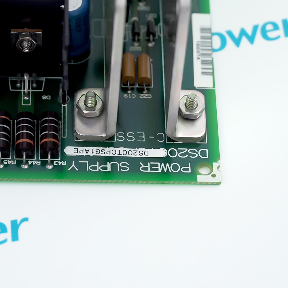 Close-up of the board legend reading POWER SUPPLY and DS200TCPSG1APE beside the mounting studs and filter capacitors