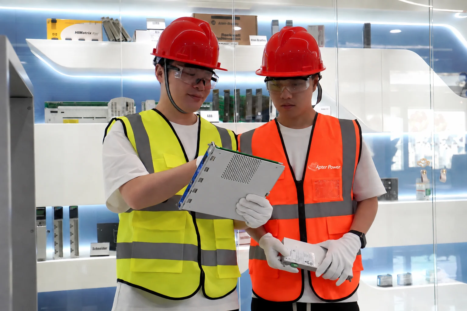 Two Apter Power team members reviewing industrial automation parts together